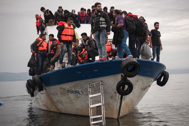 Migrants and refugees are seen aboard a Turkish fishing boat