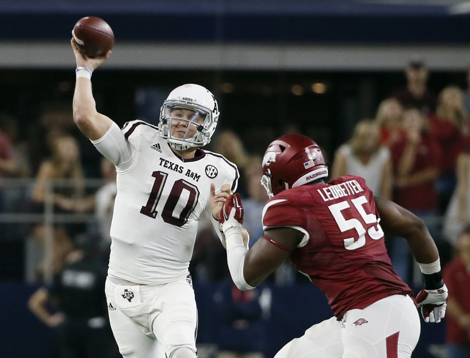 Texas A&M quarterback Kyle Allen passes under pressure from Arkansas defensive lineman Jeremiah Ledbetter during the second half on Saturday Sept. 26 2015 in Arlington. Allen completed passes for 358 yards with two touchdowns in the 28-21 Texa