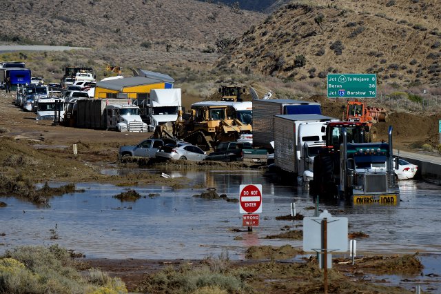 Bill Beaury with Golden Empire Towing works to remove vehicles on California 58 east of Tehachapi Calif. on Saturday Oct. 17 2015. Emergency crews were working to dig out head-high mounds of mud from the 58 and Interstate 5 which was also shut down