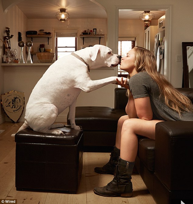 Ronda Rousey plants a kiss on her pet dog Mochi as she