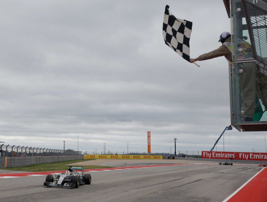 Mercedes driver Lewis Hamilton of Britain crosses the finish line to win the world championship after his victory at the Formula One U.S. Grand Prix auto race at the Circuit of the Americas Sunday Oct. 25 2015 in Austin Texas