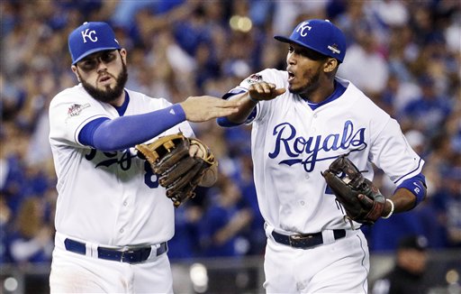 Kansas City Royals third baseman Mike Moustakas let and shortstop Alcides Escobar celebrates the end of the top of the fifth inning in Game 6 of baseball's American League Championship Series against the Toronto Blue Jays on Friday Oct. 23 2015