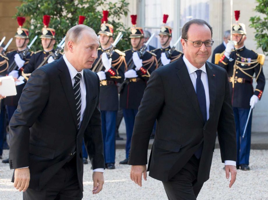 French President Francois Hollande right greets his Russian counterpart Vladimir Putin upon his arrival at the Elysee Palace in Paris France Friday Oct. 2 2015 Russian President Vladimir Putin is meeting the leaders of Ukraine France and Germany