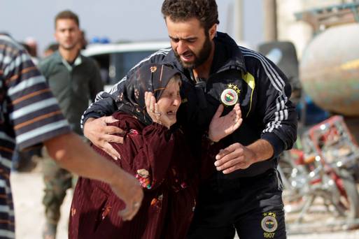 A man comforts a woman whose relatives were killed at a site hit by what activists were airstrikes carried out by Russian air force in Maasran town in the southern countryside of Idlib Syria