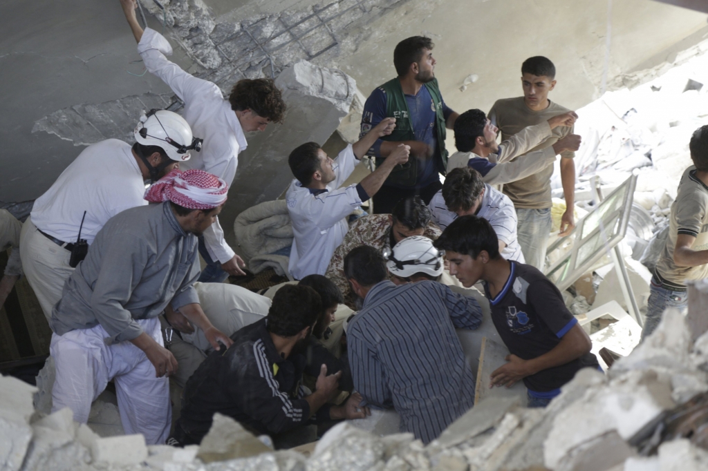 Civil defence members and civilians search for survivors under the rubble of a site hit by Russian air force in Maasran Syria. – Reuters pic