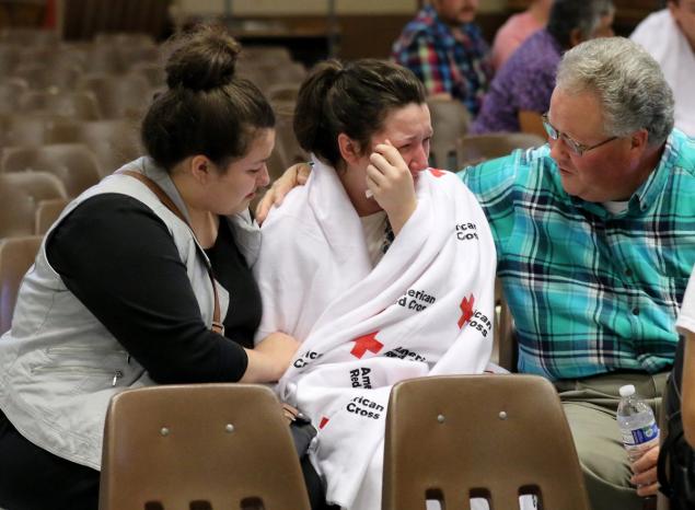 Hannah Miles center is reunited with her sister Hailey Miles and father Gary Miles after the shooting