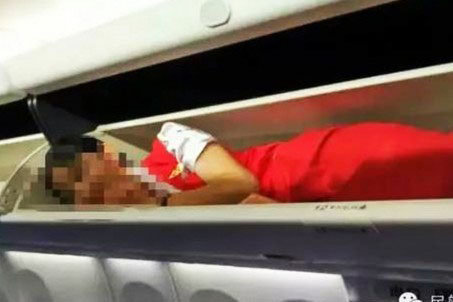 SICKENING Cabin crew have been forced into overhead lockers