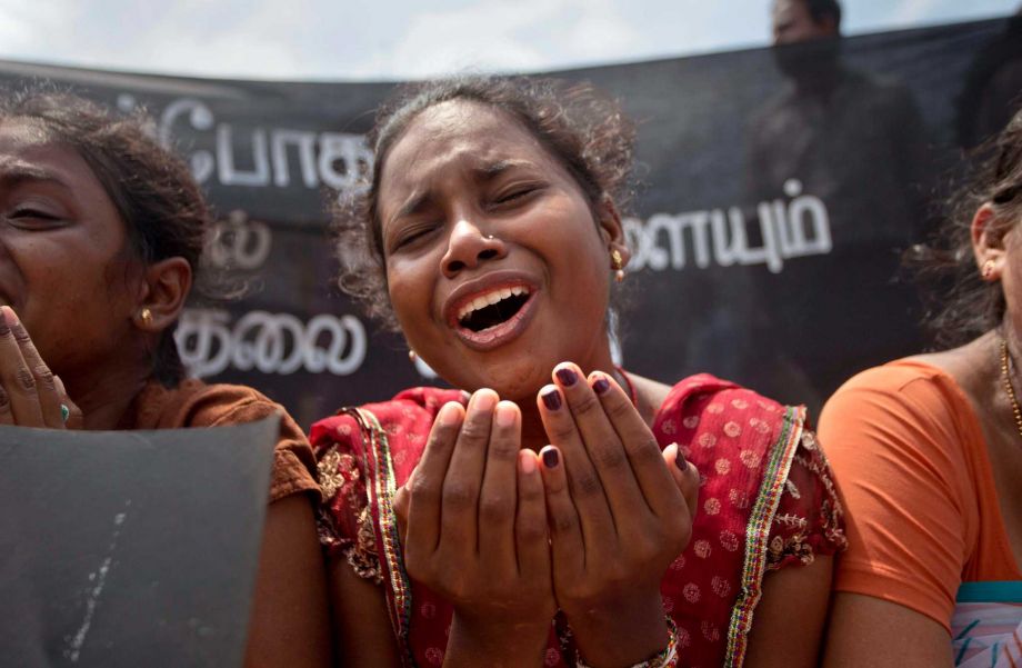 A family member of an ethnic Tamil detainee cries during a silent protest in Colombo Sri Lanka Wednesday Oct. 14 2015. Relatives and civil rights activists are demanding the Sri Lankan government to release hundreds of minority ethnic Tamils detained