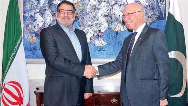 Secretary of Iran’s Supreme National Security Council Ali Shamkhani shakes hands with Pakistan Prime Minister Adviser on National Security and Foreign Affairs Sartaj Aziz in Pakistan’s capital Islamabad