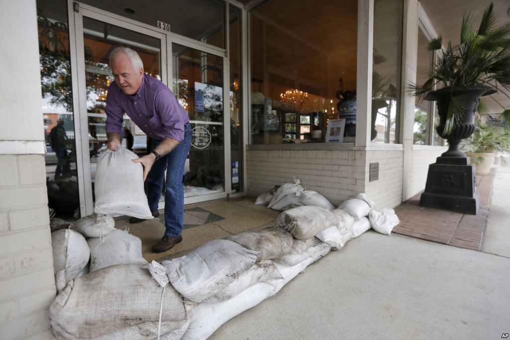 Scott Youngblood moves sandbags into place in front of the furniture store Augustus & Carolina in Georgetown S.C. Oct. 6 2015