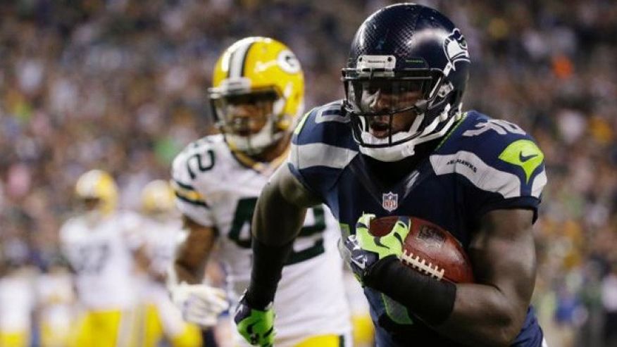 Seattle Seahawks fullback Derrick Coleman right runs for a touchdown in the second half of an NFL football game against the Green Bay Packers in Seattle