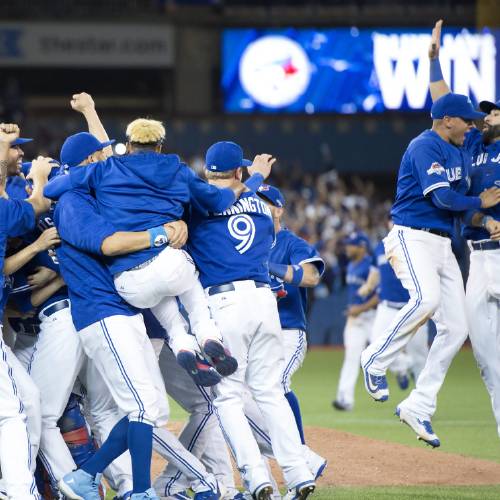 Blue Jays celebrate after winning Game 5 of baseball's American League Division Series against the Texas Rangers Wednesday Oct. 14 2015 in Toronto. The Blue Jays clinched their first trip to the American League Championship S