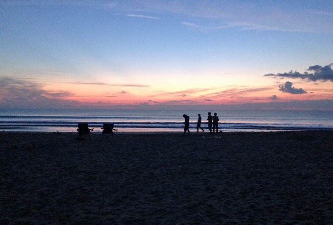 Beachgoers early Sunday enjoy the sunrise at Cocoa Beach. Today's forecast calls for spotty showers and storms but conditions will get much nicer starting Monday