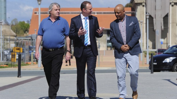 Signed up Chief Minister Andrew Barr talks with future Uber drivers Gary Woodbridge and Teferi Gungl