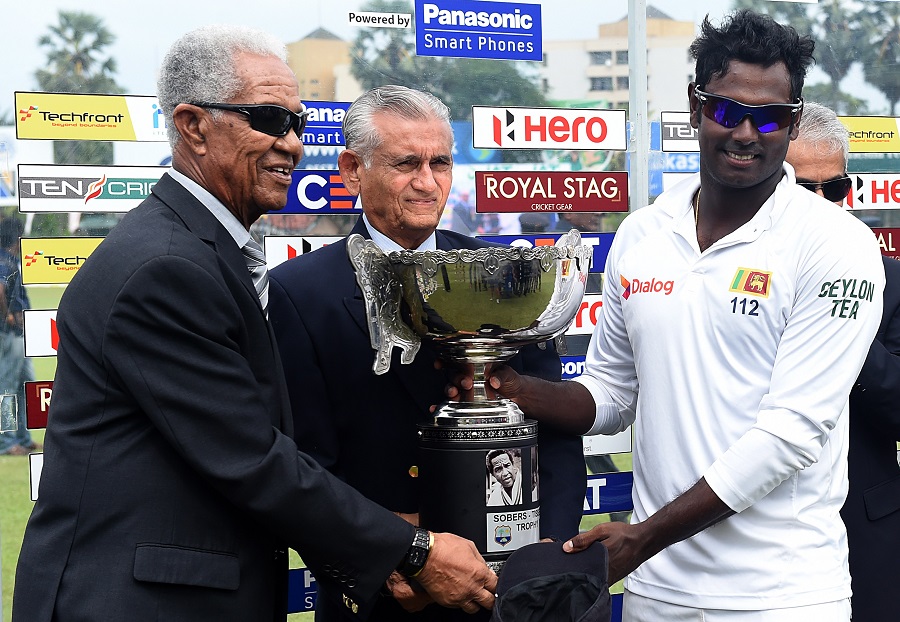 Sir Garfield Sobers and Michael Tissera handing over the winning trophy bearing their names to Sri Lankan captain Angelo Mathews