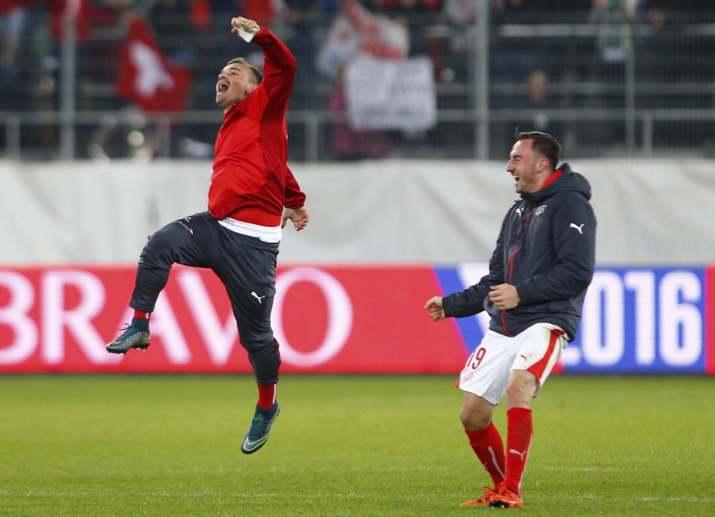 Switzerland's Xherdan Shaquiri celebrates with team mate Josip Drmic after defeating San Marino and qualifying for the Euro after their Euro 2016 Group E qualifying football match in St. Gallen Switzerland yesterday. – Reuters pic