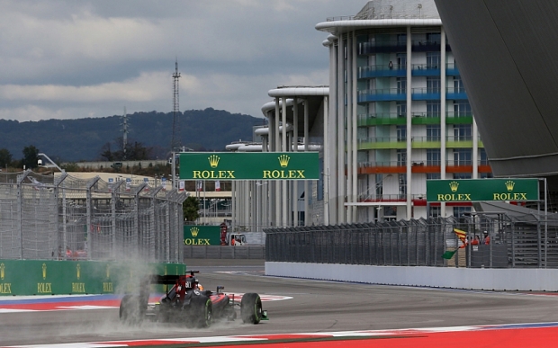 Spray flies up behind Fernando Alonso's Mc Laren in Sochi