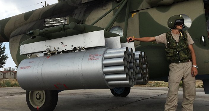 Pilot by a Russian MI-8AMShT cargo and attack helicopter at the Hmeimim air base in Syria