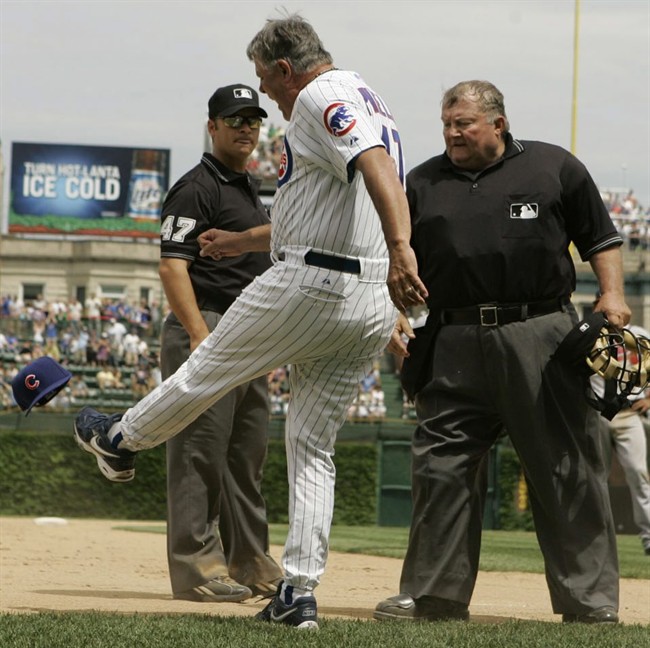 Chicago Cubs manager Lou Piniella kicks his hat as he argues with third base umpire Mark Wegner left and home plate umpire Bruce Froemming watches during the eighth inning of a baseball game against Atlanta Brave