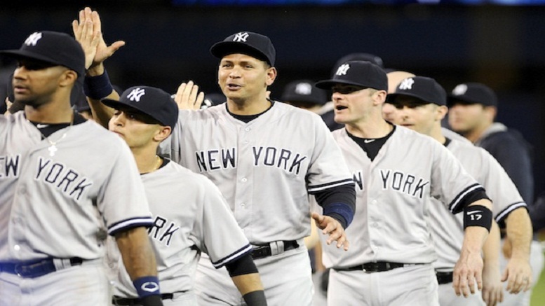 New York Yankees&#039 Alex Rodriguez center high-fives teammates after a baseball game against the Toronto Blue Jays Tuesday Sept. 22 2015 in Toronto. New York won 6-4. MANDATORY CREDIT