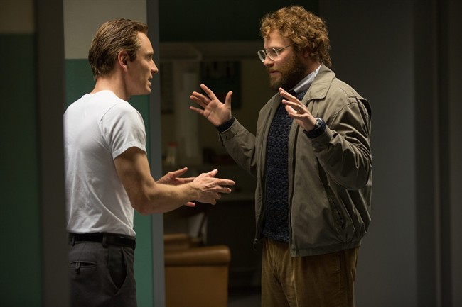 Michael Fassbender left as Steve Jobs and Seth Rogen as Steve Wozniak appear in a scene from the film'Steve Jobs. The movie releases in U.S. theaters on Friday Oct. 9 2015