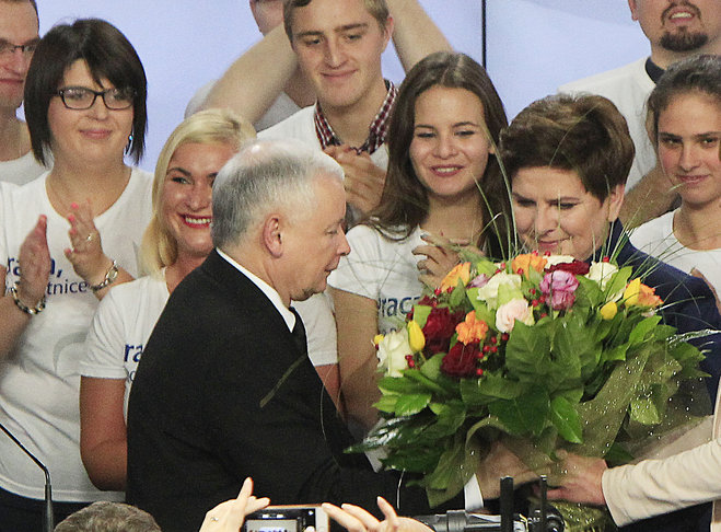 Conservative Law and Justice leader Jaroslaw Kaczynski and Justice candidate for the Prime Minister Beata Szydlo right react at the party's headquarters in Warsaw Poland on Sunday Oct.25 2015. The victory of his Eurosceptic party ends eight years