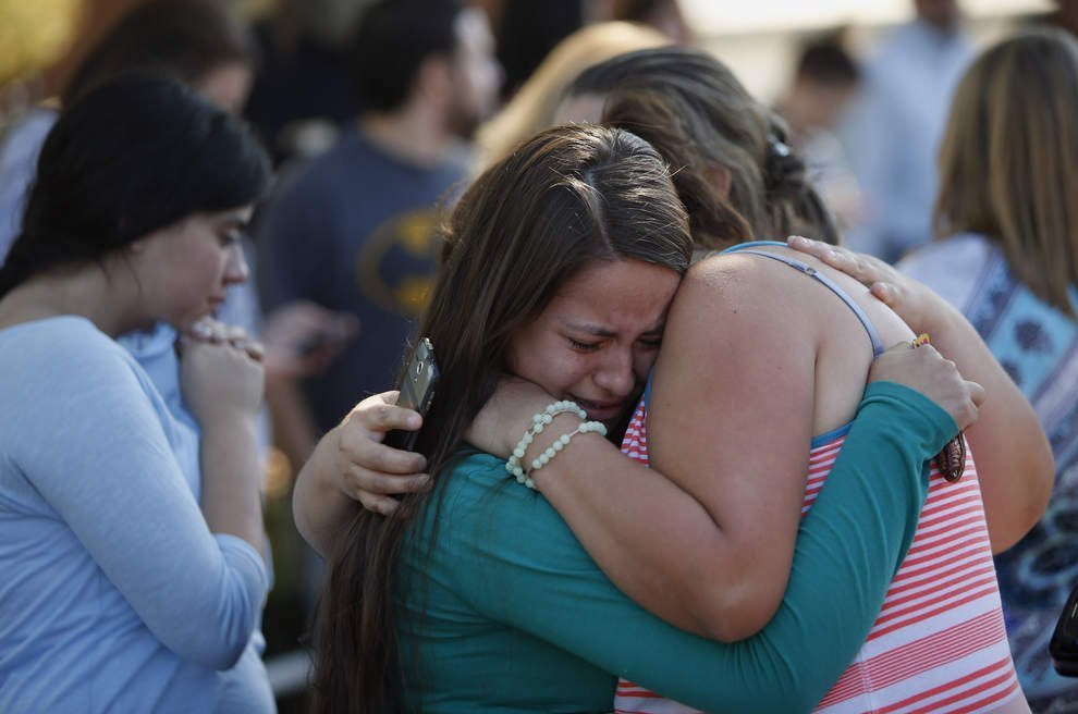 Students hug after a shooting at Oregon's Umpqua Community College in Roseburg on Thursday