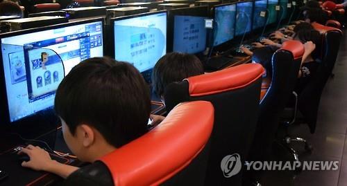 Students play video games in a PC cafe in Seoul in this file