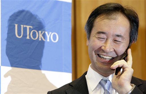 Takaaki Kajita of Japan director of the Institute for Cosmic Ray Research and professor at the University of Tokyo speaks with Japanese Prime Minister Shinzo Abe on the phone after learning he won the Nobel Prize in physics