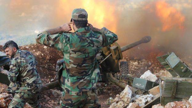 Syrian soldiers fire artillery at rebel positions in Latakia province. /AP