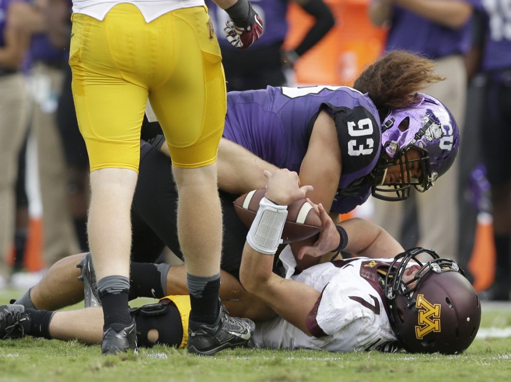 Minnesota quarterback Mitch Leidner takes a hard hit from TCU defensive end Mike Tuaua during the second half of an NCAA college football game Saturday Sept. 13 2014 in Fort Worth Texas. Leidner left the game after the play. TCU won 30-7