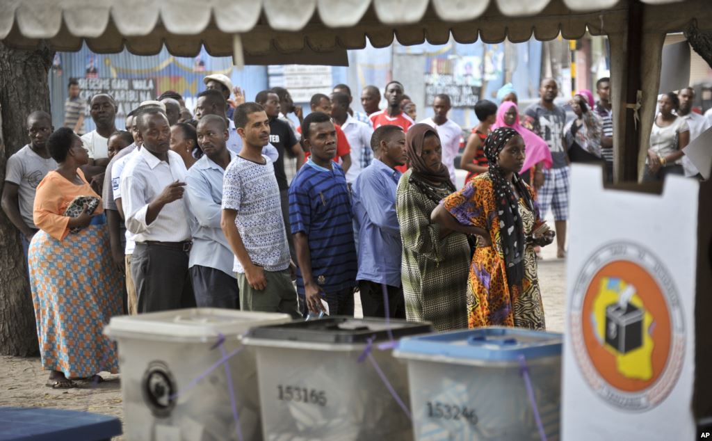 Tanzanians queue to cast their votes in the presidential election at a polling station in Dar es Salaam Tanzania Oct. 25 2015