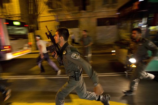 Israeli policemen run looking for a possible stabbing suspect in Jerusalem. A sudden wave of stabbing attacks has spread fear in Jerusalem and much of Israel