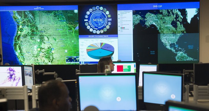 Staff members sit at their work stations at the National Cybersecurity and Communications Integration Center in Arlington Virginia