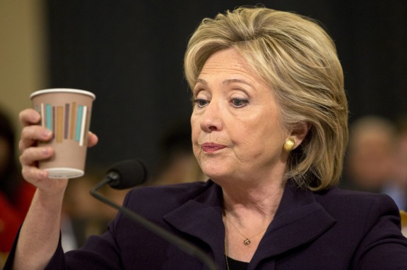 Former Secretary of State Hillary Clinton takes a sip from a cup during the final hour of her Benghazi testimony last Thursday