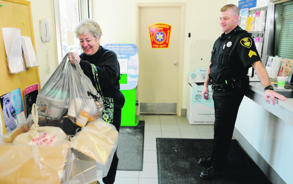 Carmen Mc Curdy left chats with Gardiner Police Sgt. Todd Pillsbury as she drops of medicine during annual drug take back event in April 2013 at Gardiner Police station