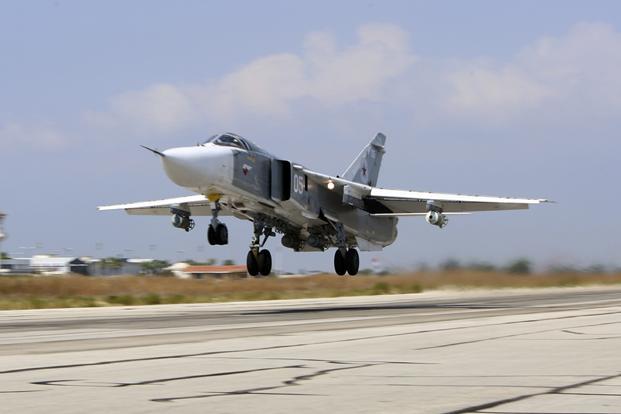 Russian SU-24M jet fighter armed with laser guided bombs takes off from a runaway at Hmeimim airbase in Syria
