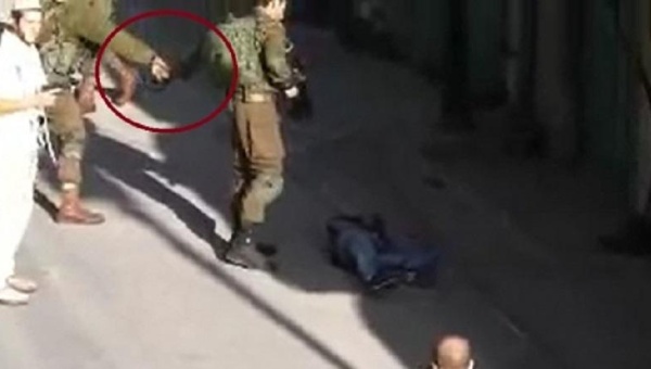 This video has raised concerns about a solider possibly planting evidence on a slain Palestinian