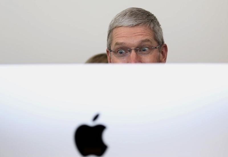 Apple CEO Tim Cook looks at a new IMac after a presentation at Apple headquarters in Cupertino California