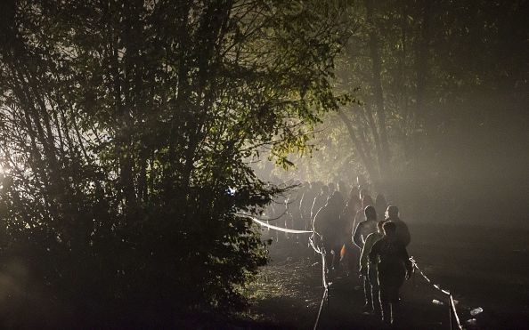 Migrants walk to the border with Hungary