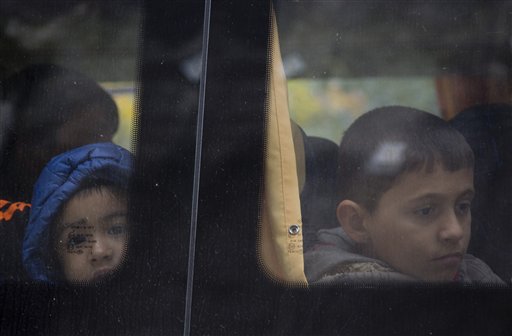 Children wait in a bus to be transferred to Austria in Gruskovje on the Croatian Slovenian border Saturday Oct. 17 2015. Hungary shut down its border with Croatia to the free flow of migrants prompting Croatia to redirect thousands of people toward