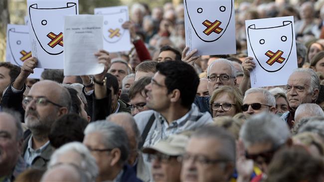 People hold up posters as Catalonia's regional government president and leader of the Catalan Democratic Convergence Artur Mas appears at the Supreme Court of Catalonia in Barcelona Spain