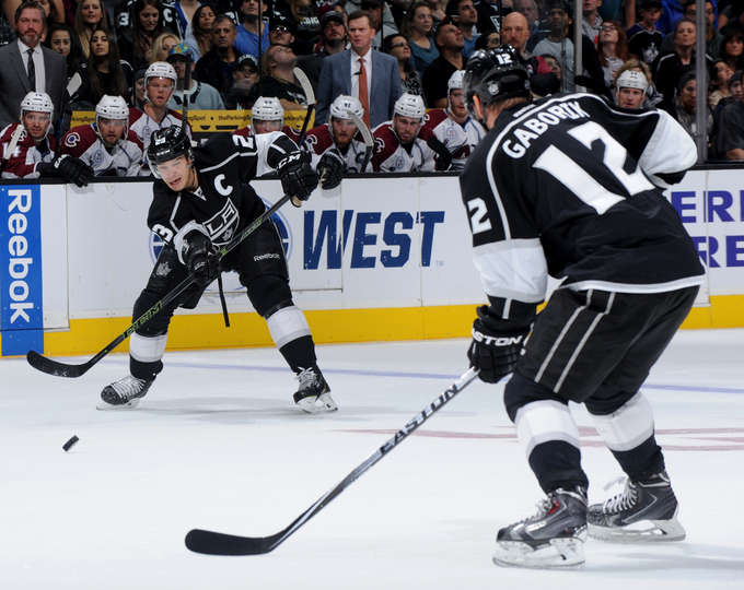 LOS ANGELES CA- OCTOBER 18 Dustin Brown #23 of the Los Angeles Kings makes the pass to teammate Marian Gaborik #12 during the game against the Colorado Avalanche at STAPLES Center