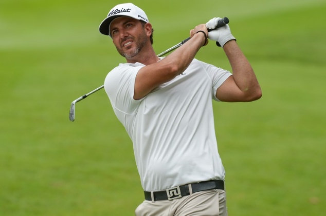 Scott Piercy of the US watches his shot on the 18th hole in the first round of the CIMB Classic golf tournament in Kuala Lumpur