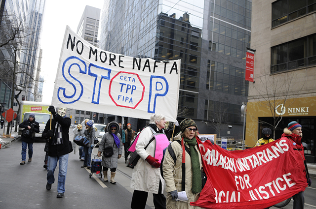 31 January 2014 Protesters marching in a rally to protest the proposed Trans Pacific Partnership and North American Free Trade Agreement in Toronto Canada