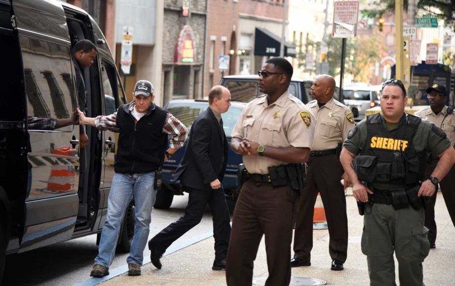 Baltimore city police officers charged in connection with Freddie Gray's death including officer Lt. Brian W. Rice third from left arrive at a side door for a court appearance on Tuesday Oct. 13 2015 in Baltimore. All six officers appeared before