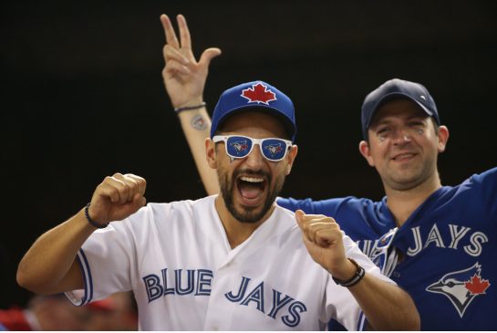 Blue Jays fan celebrate during Game 3 of the Blue Jays Rangers ALDS series in Arlington Texas on Sunday. The teams will play again Monday afternoon after the Jays 5-1 victory kept their playoff hopes alive