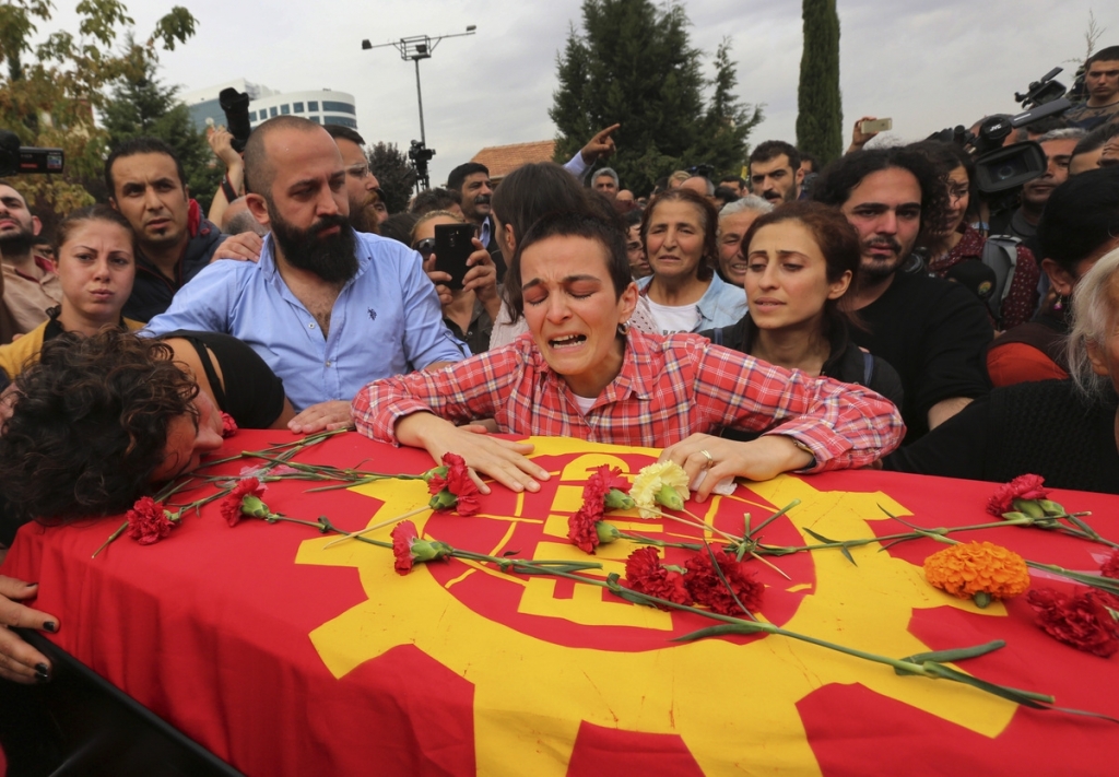 Relatives cry over the coffin of Korkmaz Tedik 25 killed in Saturday's bombing attacks during his funeral at the Pir Sultan Abdal Cemevi a place of worship for Turkey’s Alevi community in the outskirts of Ankara Turkey Sunday Oct. 11 2015. Turk