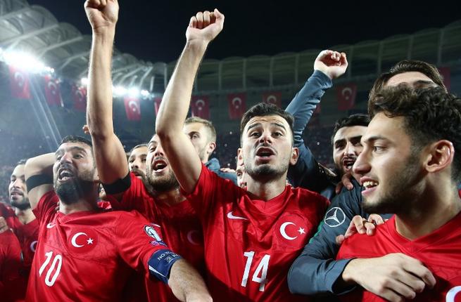 Turkey's players celebrate after defeating Iceland in a Euro 2016 Group A qualifying football match between Turkey and Iceland