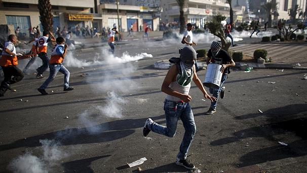 Palestinians burn tires during clashes with Israeli troops near Ramallah West Bank Friday Oct. 16 2015. Tensions and violence have been mounting in recent weeks in part fueled by Palestinian fears that Israel is trying to expand its presence at a maj